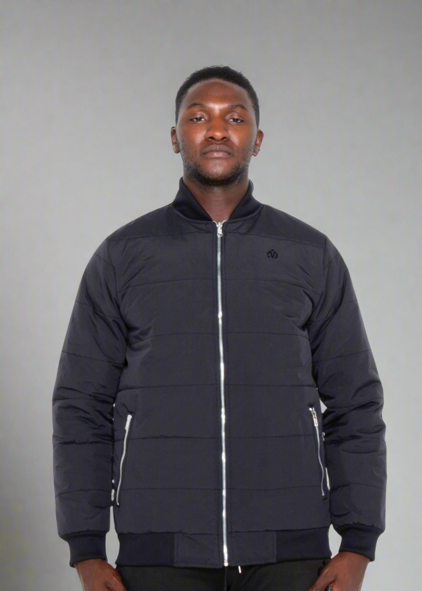 man wearing black quilted jacket with ky zipper