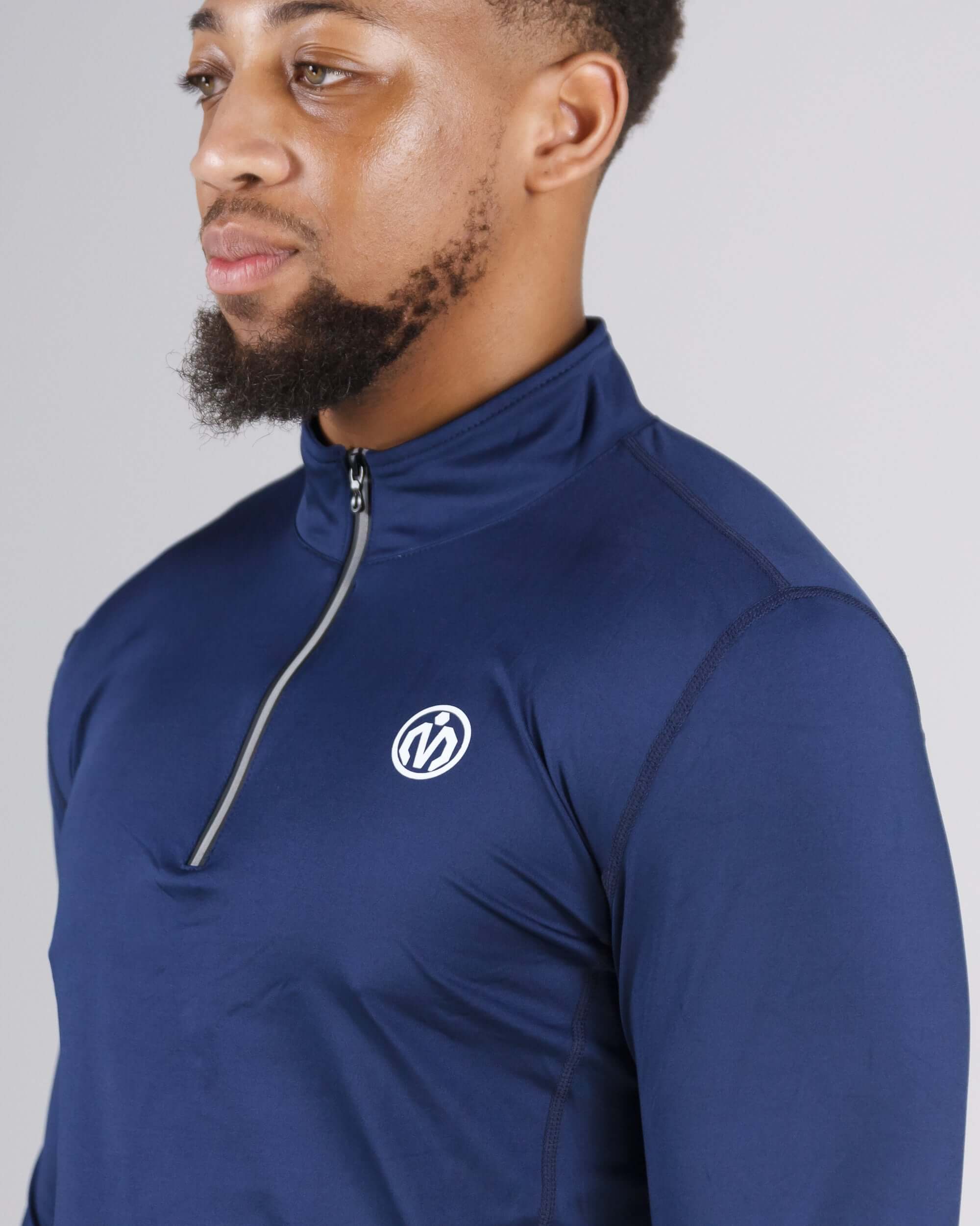 Man wearing navy Pinnacle Dry-Fit Long Sleeve Half Zip Training Top for workouts and outdoor training sessions