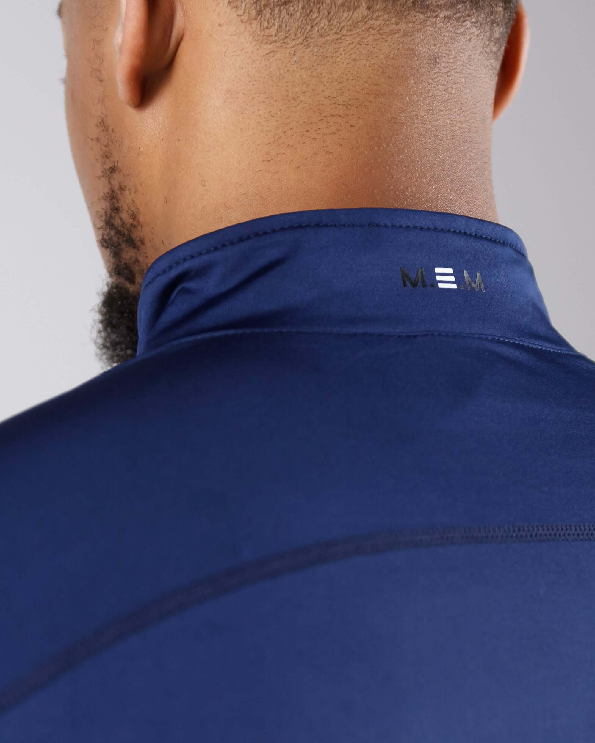 Close-up back view of the navy blue Pinnacle Dry-Fit Long Sleeve Half Zip Training Top in use