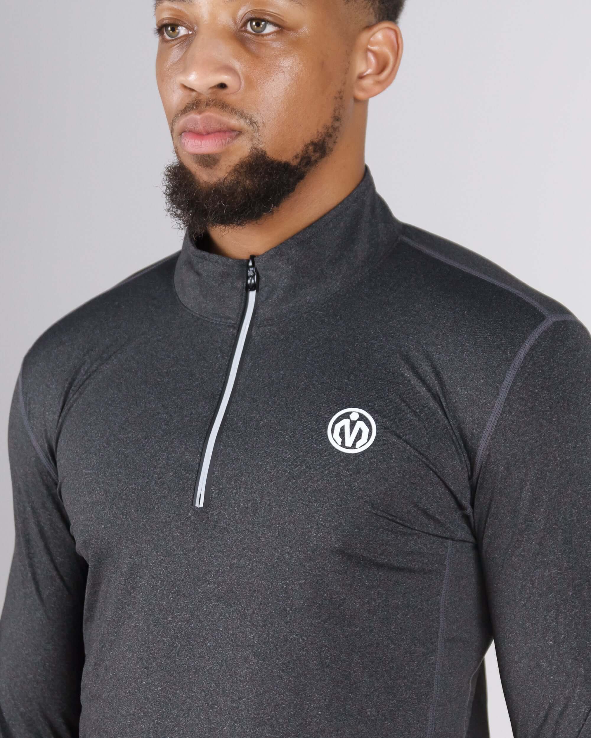 Man wearing Pinnacle Dry-Fit Long Sleeve Half Zip Training Top in grey for enhanced workout performance.